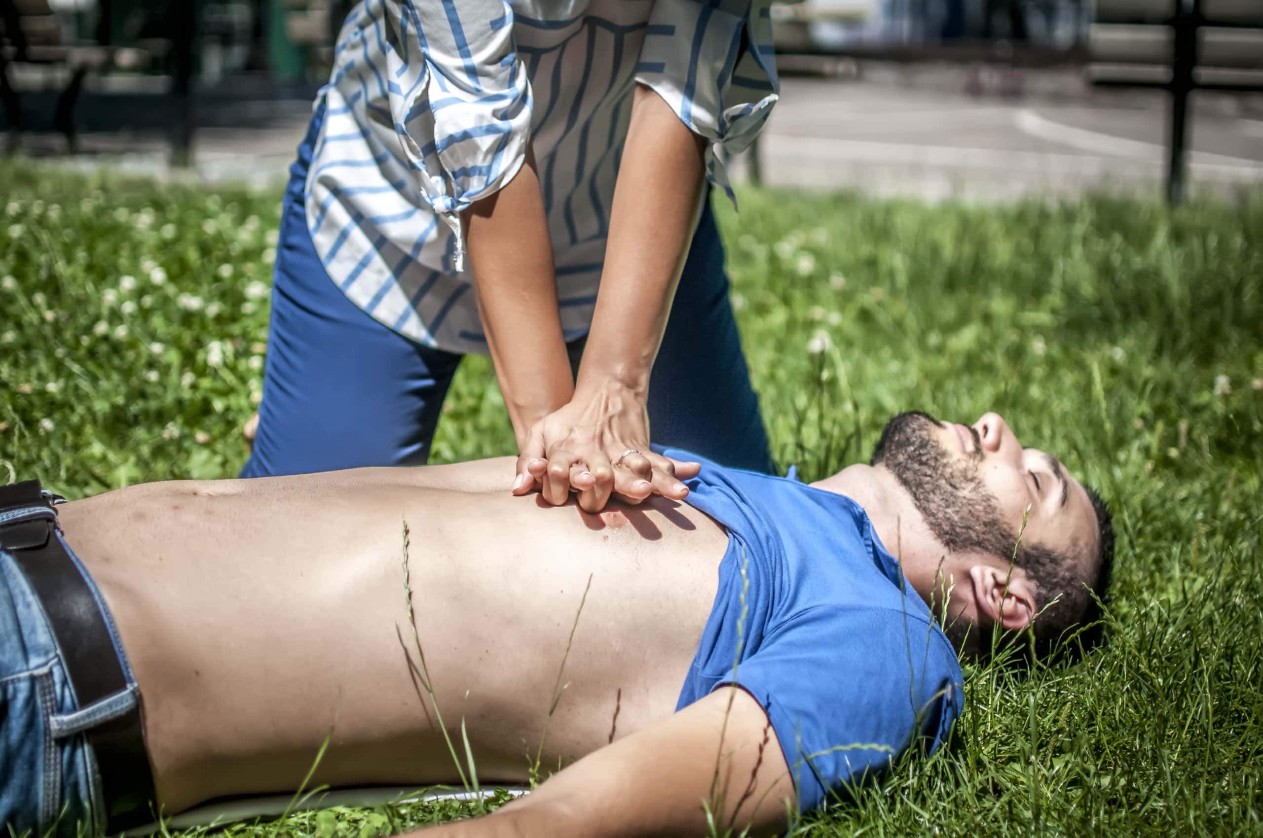 Emergency CPR on a Man who has Heart Attack on the grass